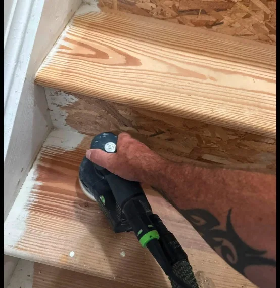 Detail sanding on a South Florida stair tread before coating