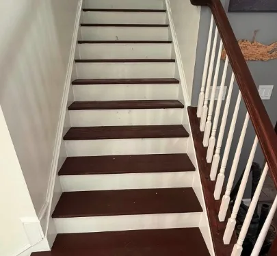 Finished South Florida staircase with stained wood treads and clean painted risers